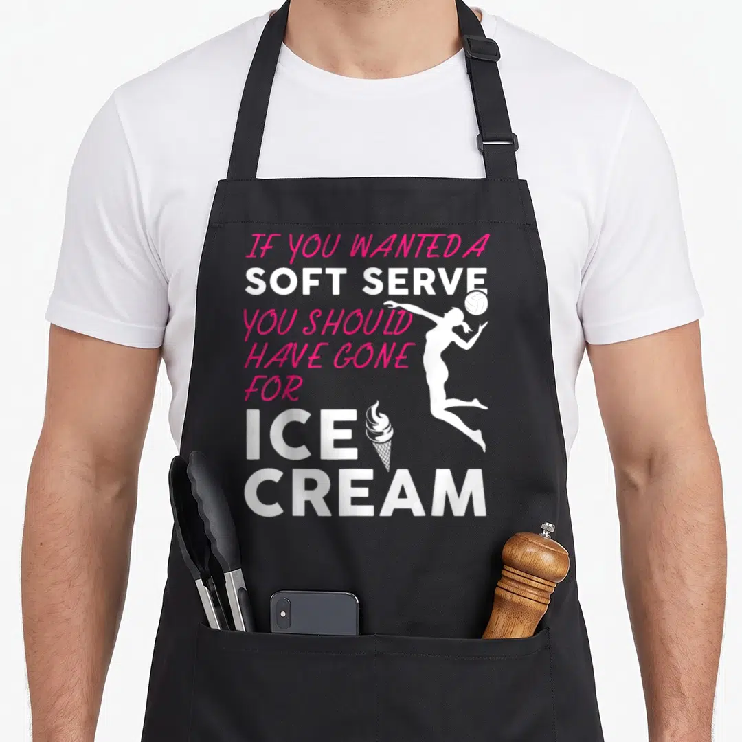 Wanted volleyball to serve man apron - Pink and white text reading IF YOU WANTED A SOFT SERVE YOU SHOULD HAVE GONE — shown on a black cotton canvas apron against a white background