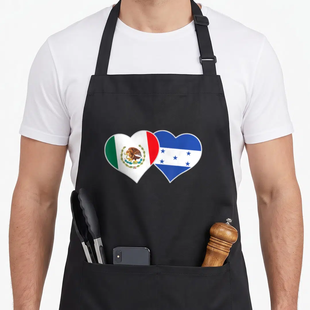 Honduran mexican apron - Two overlapping hearts filled with the green white red Mexican flag and blue white Honduran — shown on a black cotton canvas apron against a white background