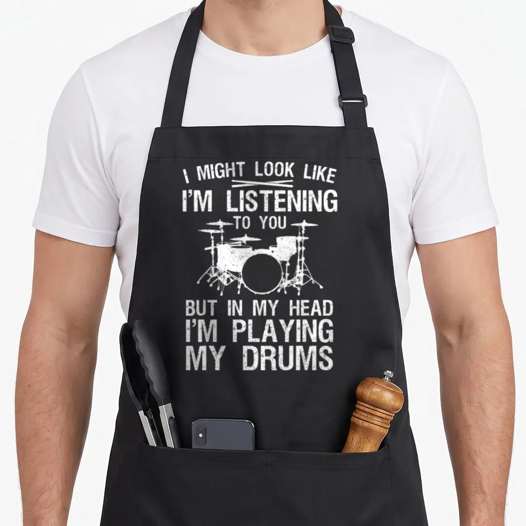 Playing drum apron - White distressed drum kit with sarcastic text on black bib apron — shown on a black cotton canvas apron against a white background
