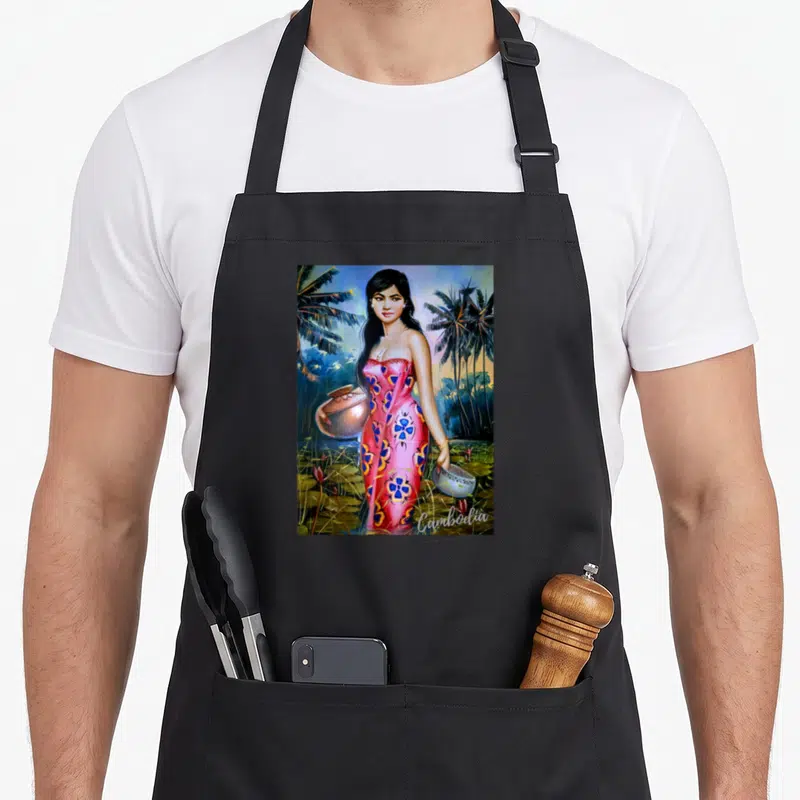 Cambodian beautiful apron - Realistic woman in pink dress holding pot and bowl among palm trees with Cambodia text — shown on a black cotton canvas apron against a white background