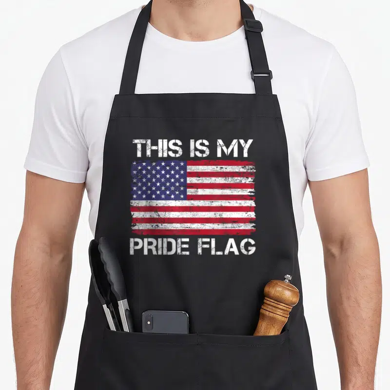 Pride 4th of july apron - Distressed USA flag with THIS IS MY PRIDE FLAG text in white red and blue — shown on a black cotton canvas apron against a white background