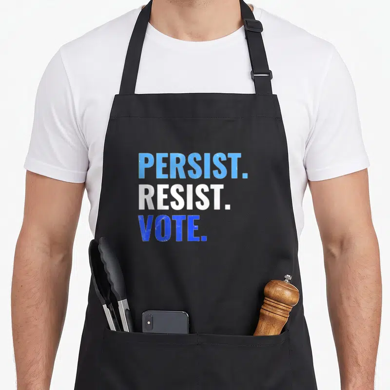 Persist rally apron - Stacked blue and white text reading PERSIST. RESIST. VOTE. on black fabric — shown on a black cotton canvas apron against a white background