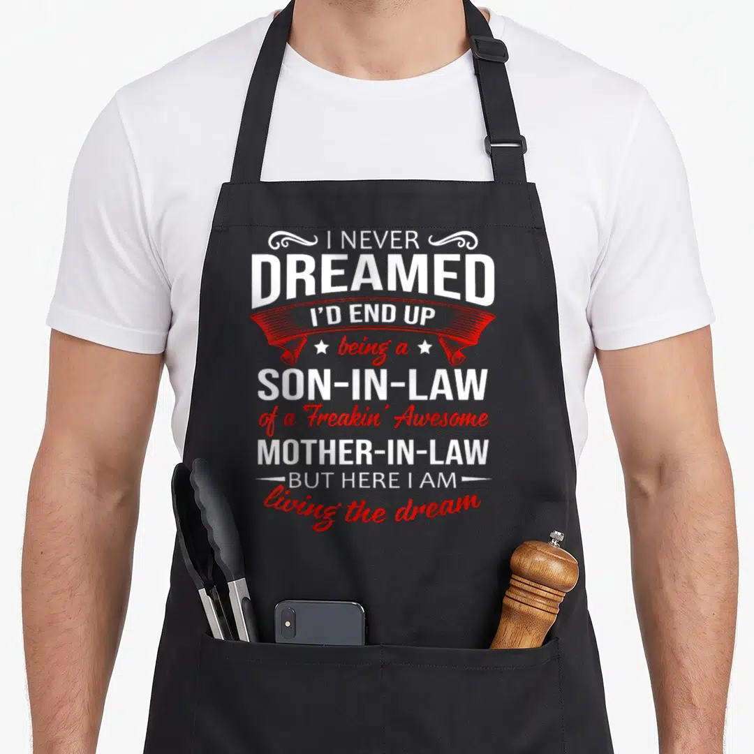 End dreamed apron - Stacked white and red text reading I Never Dreamed I End Up Son In Law Mother In Law — shown on a black cotton canvas apron against a white background