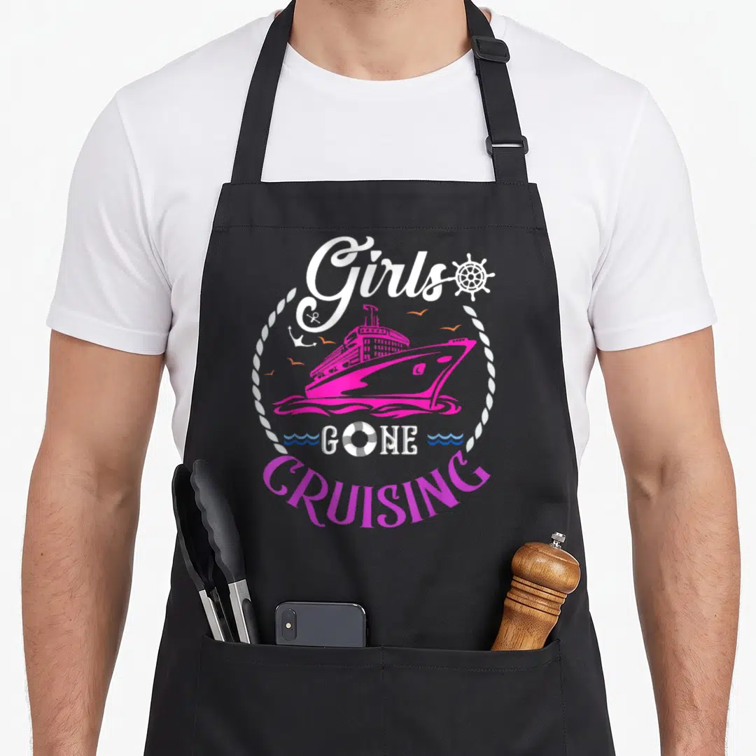 Gone cruising apron - Pink cruise ship in rope circle with Girls Gone Cruising text and ship wheel — shown on a black cotton canvas apron against a white background
