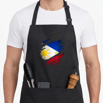 Unity pride apron - Distressed splatter effect Philippines flag in blue red white and yellow with sun and star details — shown on a black cotton canvas apron against a white background