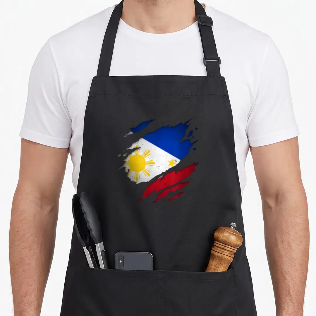 Unity pride apron - Distressed splatter effect Philippines flag in blue red white and yellow with sun and star details — shown on a black cotton canvas apron against a white background