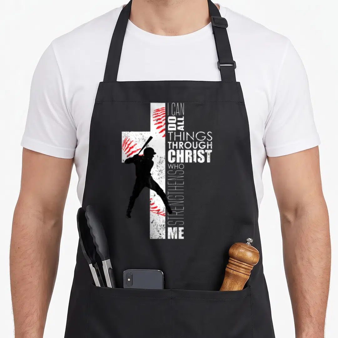 Christian baseball cross apron - Distressed white cross with red stitching and black batter silhouette beside vertical — shown on a black cotton canvas apron against a white background