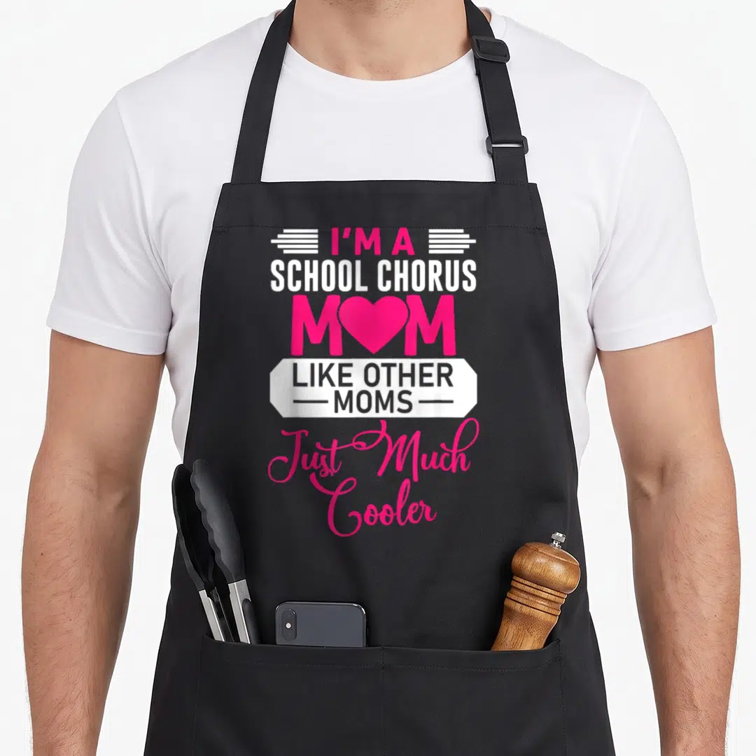 School mother's day aprons - Pink and white text reading I'm a School Chorus Mom with heart replacing O and banner — shown on a black cotton canvas apron against a white background