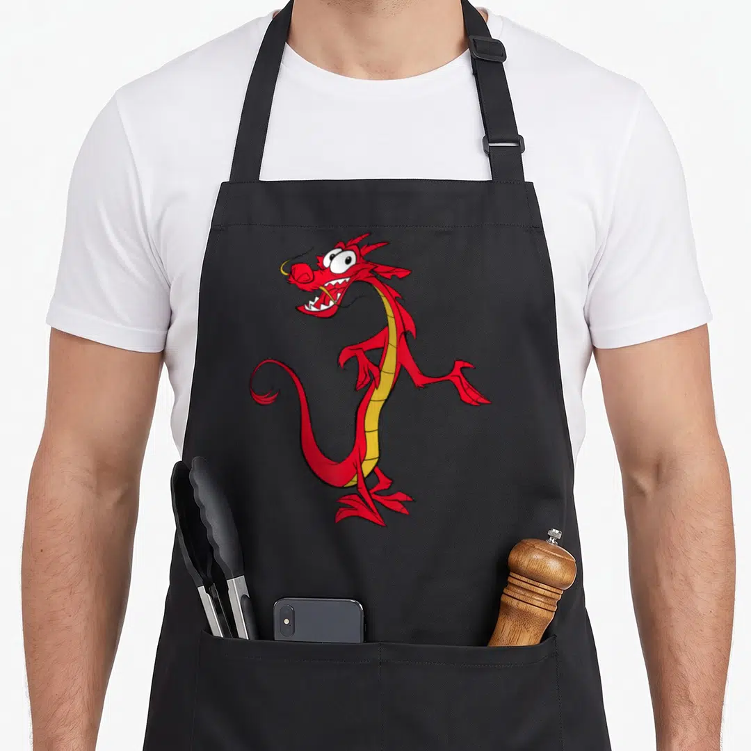 Mushu dragon apron - Red cartoon dragon with yellow belly standing upright with open mouth — shown on a black cotton canvas apron against a white background
