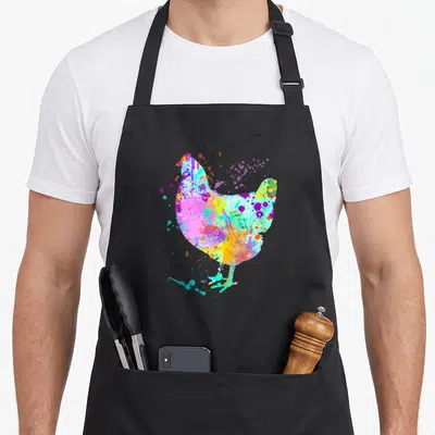 Watercolor chicken apron - Multicolored watercolor chicken silhouette with pink, blue, yellow, purple, and green — shown on a black cotton canvas apron against a white background