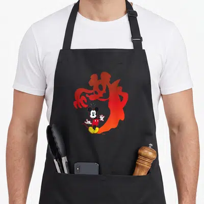 Shadow halloween apron - Mickey Mouse cartoon standing in front of a large red gradient vampire silhouette — shown on a black cotton canvas apron against a white background