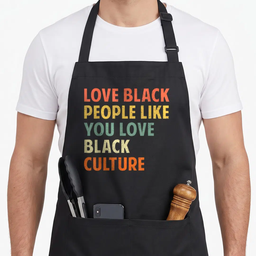 Culture urban apron - Stacked vintage typography reading LOVE BLACK PEOPLE LIKE YOU LOVE BLACK CULTURE in orange yellow — shown on a black cotton canvas apron against a white background