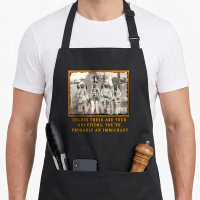 Immigration native american apron - Four Native Americans in sepia photo with orange frame and text about ancestors — shown on a black cotton canvas apron against a white background