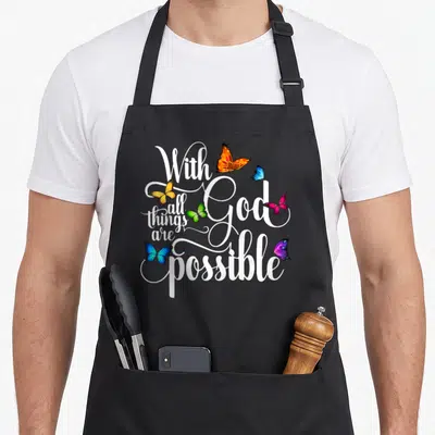 God butterfly apron - White script With all things are God possible with six colorful butterflies scattered around — shown on a black cotton canvas apron against a white background