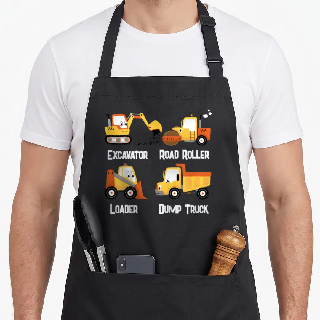Toddler dump truck apron - Four cartoon construction vehicles labeled Excavator Road Roller Loader Dump Truck in yellow — shown on a black cotton canvas apron against a white background