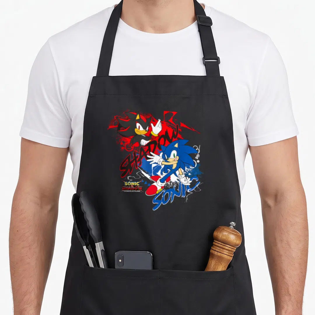 Generation x apron - Sonic and Shadow cartoon characters with stylized SHADOW SONIC GENERATIONS text in blue red black — shown on a black cotton canvas apron against a white background