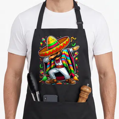 Dabbing poncho mexican apron - Cartoon mariachi dabbing with maracas, chilies, confetti in yellow red green blue white — shown on a black cotton canvas apron against a white background