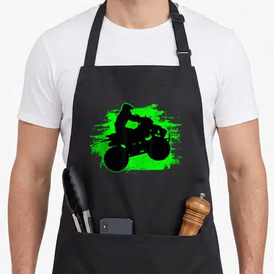 Quad atv bike apron - Black ATV rider silhouette on neon green paint splatter graphic — shown on a black cotton canvas apron against a white background