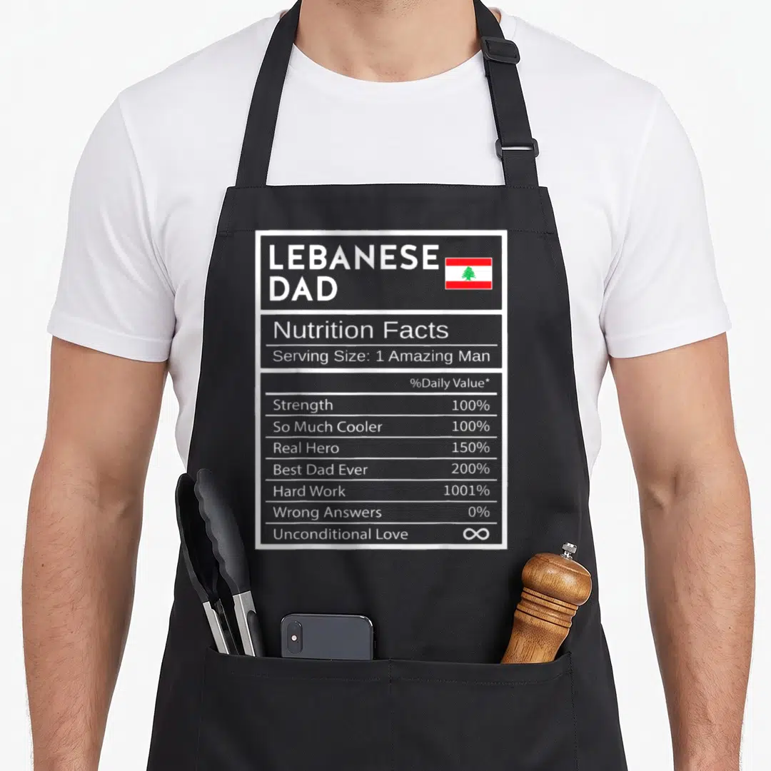Lebanese pride apron - Nutrition facts label graphic for Lebanese Dad with flag and percentages — shown on a black cotton canvas apron against a white background