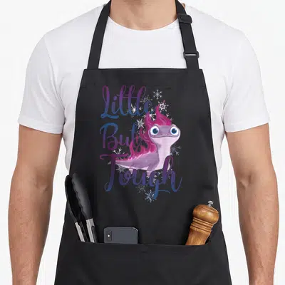 But frozen apron - Purple salamander with pink flames and Little But Tough text surrounded by snowflakes — shown on a black cotton canvas apron against a white background