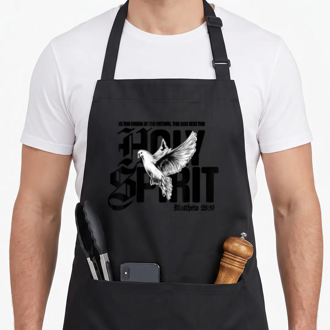 Trinity holy christian apron - White dove superimposed over HOLY SPIRIT text and Matthew 28:19 in black line art — shown on a black cotton canvas apron against a white background