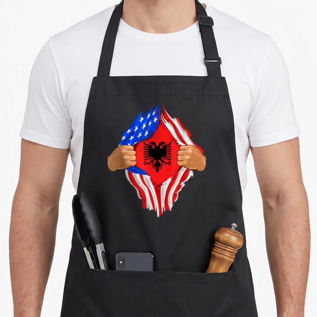 Albanian blood apron - Two hands tear USA flag to reveal red Albanian flag with black double-headed eagle — shown on a black cotton canvas apron against a white background