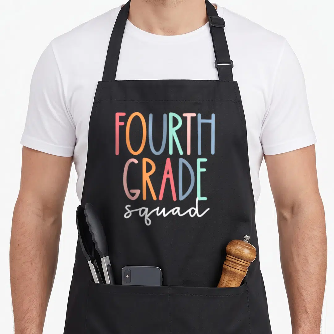 Squad 4th teacher apron - Stacked text FOURTH GRADE squad in red orange blue green pink white typography — shown on a black cotton canvas apron against a white background