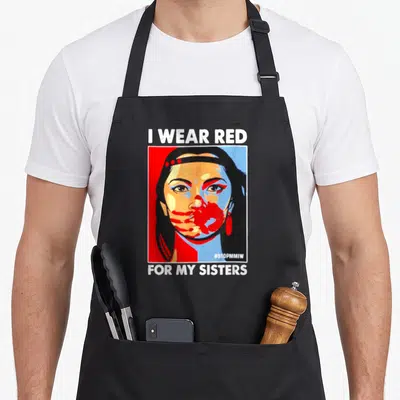 Sister native american apron - Pop art portrait of woman with I WEAR RED text and red hand covering mouth — shown on a black cotton canvas apron against a white background