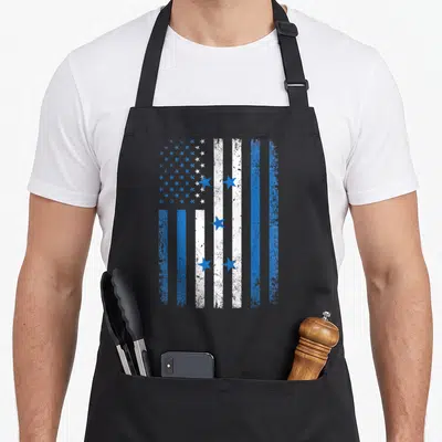 Honduras 4th of july apron - Distressed blue and white flag with stars and vertical stripes representing combined — shown on a black cotton canvas apron against a white background