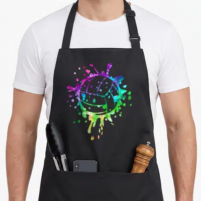 Distressed tie-dye apron - Watercolor volleyball in purple, blue, green, yellow, and pink splatter design on black — shown on a black cotton canvas apron against a white background