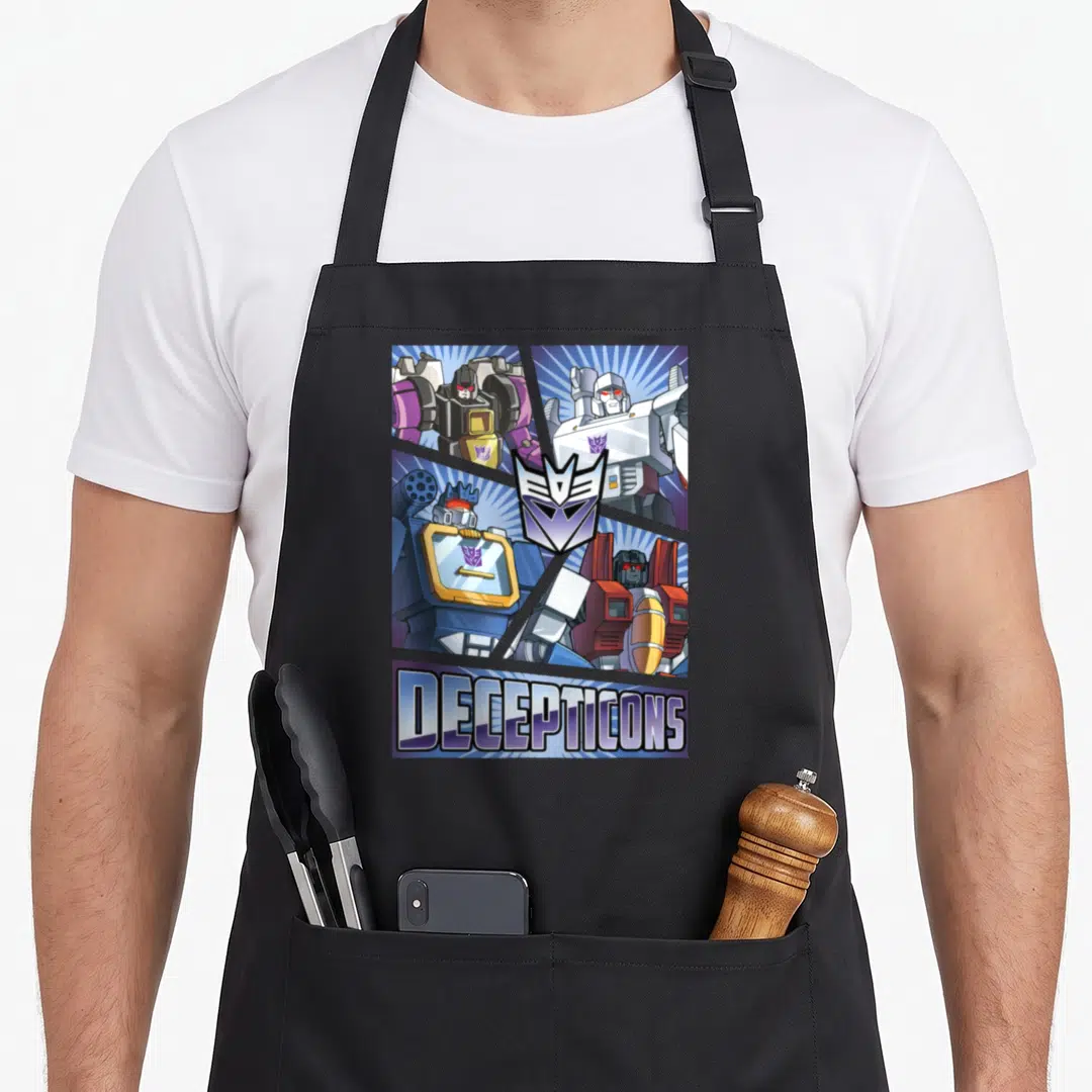 Cut transformer apron - Four robots in grid with purple Decepticon logo and bottom text banner — shown on a black cotton canvas apron against a white background
