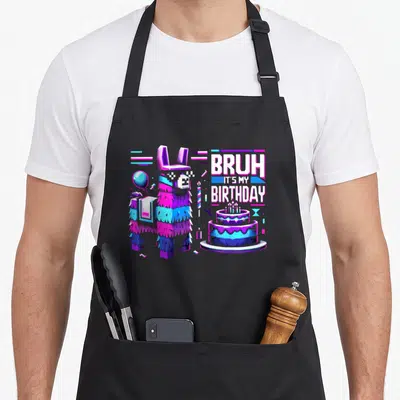 Llama video game apron - Pixel-art llama pinata with gift, balloon, cake, and stacked text BRUH IT'S MY BIRTHDAY — shown on a black cotton canvas apron against a white background