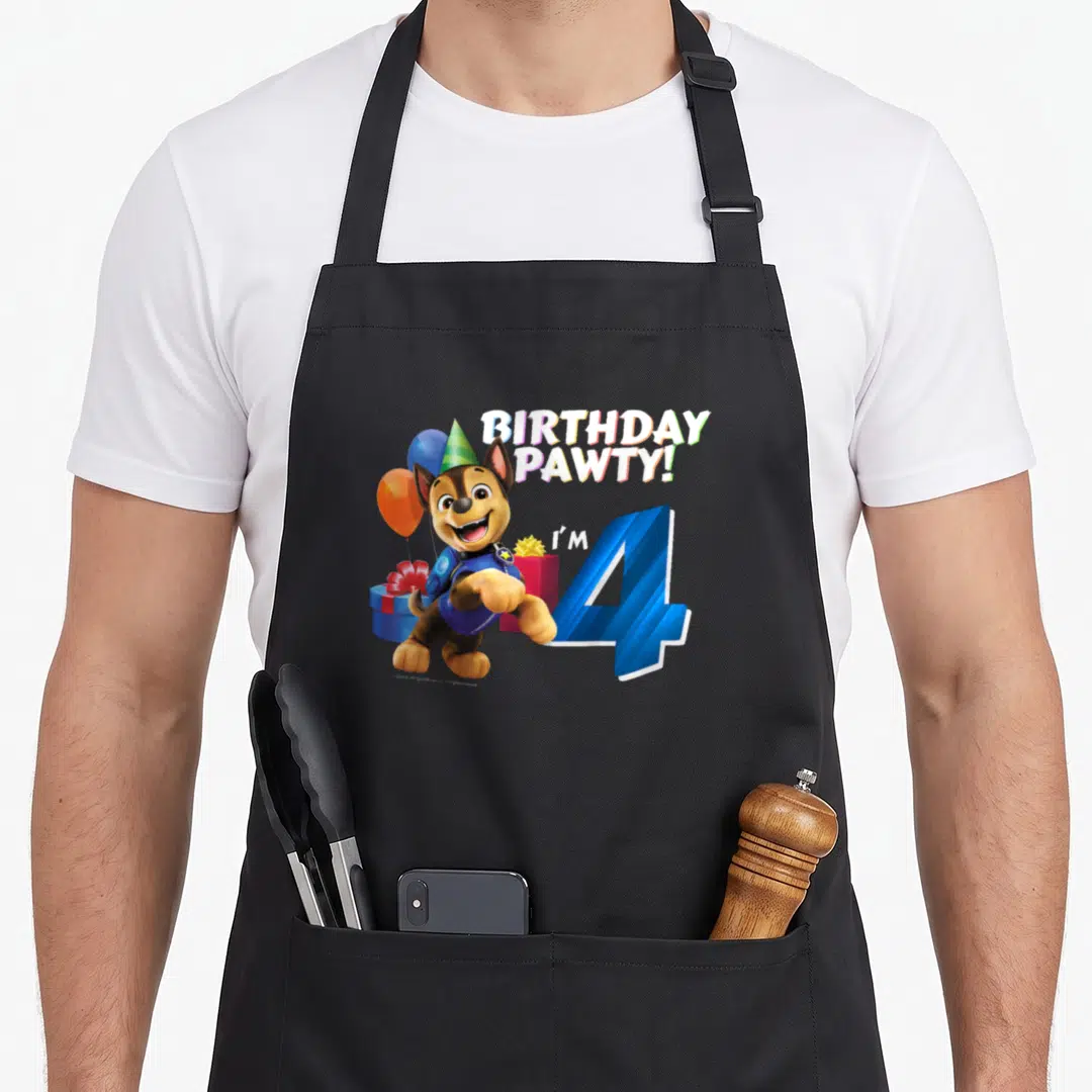 Chase bday apron - Cartoon dog wearing hat next to blue number 4 and Birthday Pawty text — shown on a black cotton canvas apron against a white background
