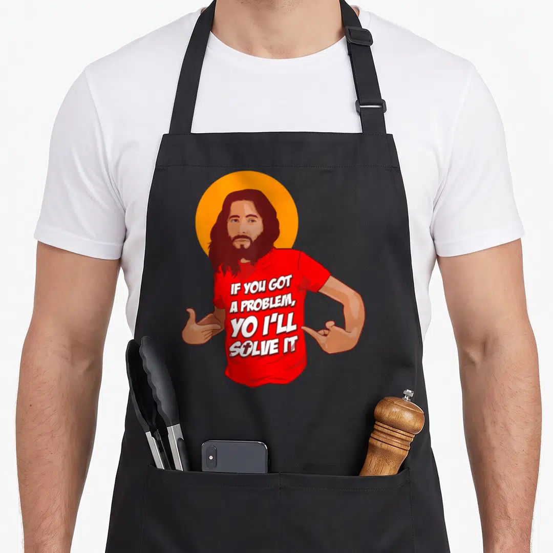 Jesus christmas apron - Cartoon man with beard pointing to red shirt text IF YOU GOT A PROBLEM YO I'll Solve It — shown on a black cotton canvas apron against a white background