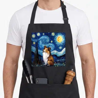 Starry sheltie apron - Realistic dog sitting under swirling blue night sky with yellow stars and dark cypress tree — shown on a black cotton canvas apron against a white background