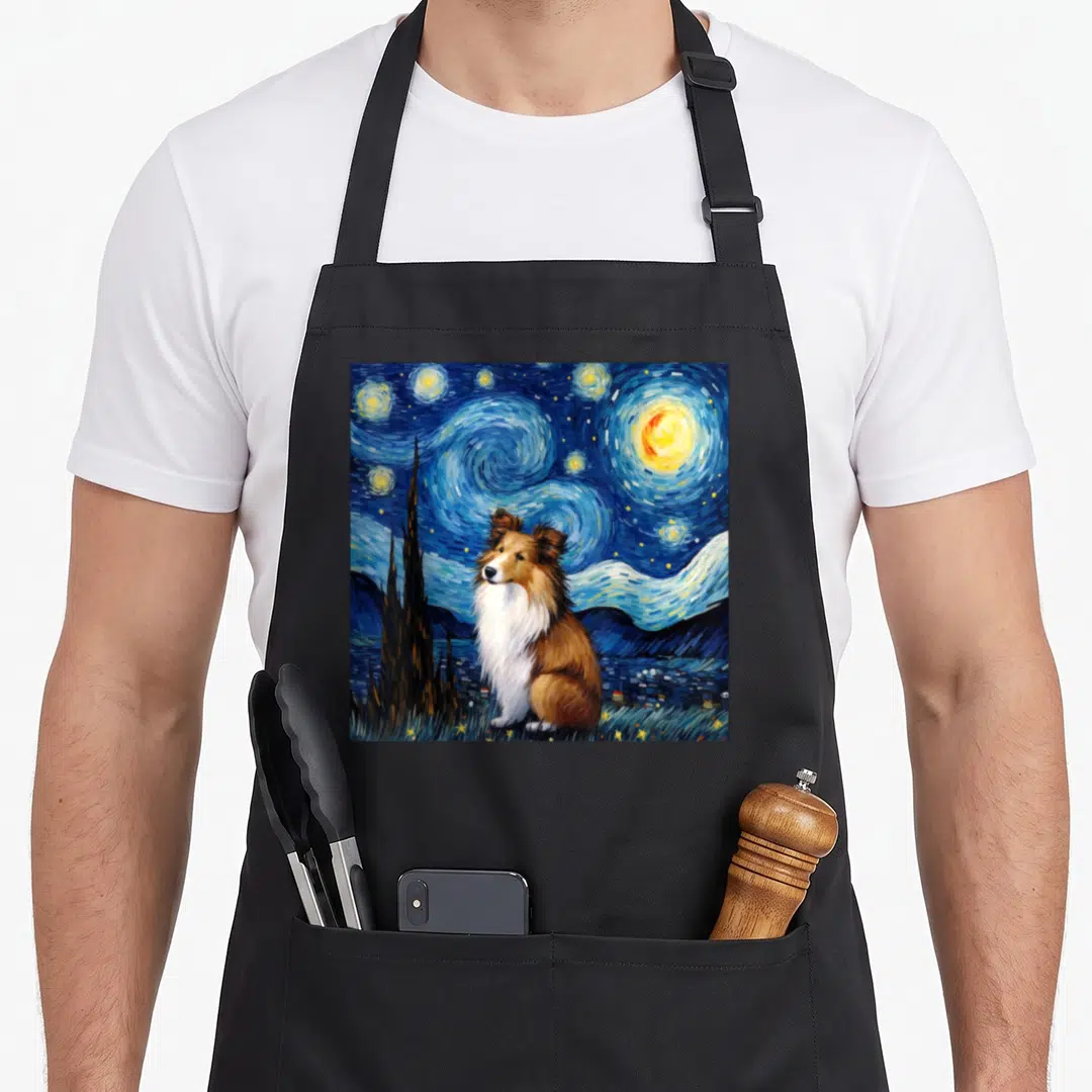 Starry sheltie apron - Realistic dog sitting under swirling blue night sky with yellow stars and dark cypress tree — shown on a black cotton canvas apron against a white background