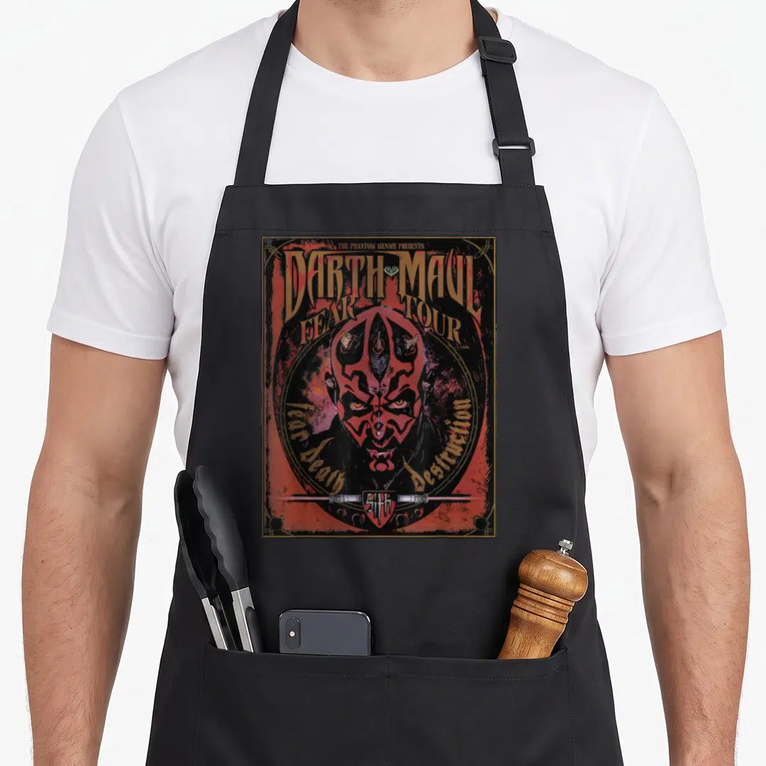 Maul fear apron - Darth Maul face in circle with Fear Death Destruction text and horizontal lightsaber — shown on a black cotton canvas apron against a white background