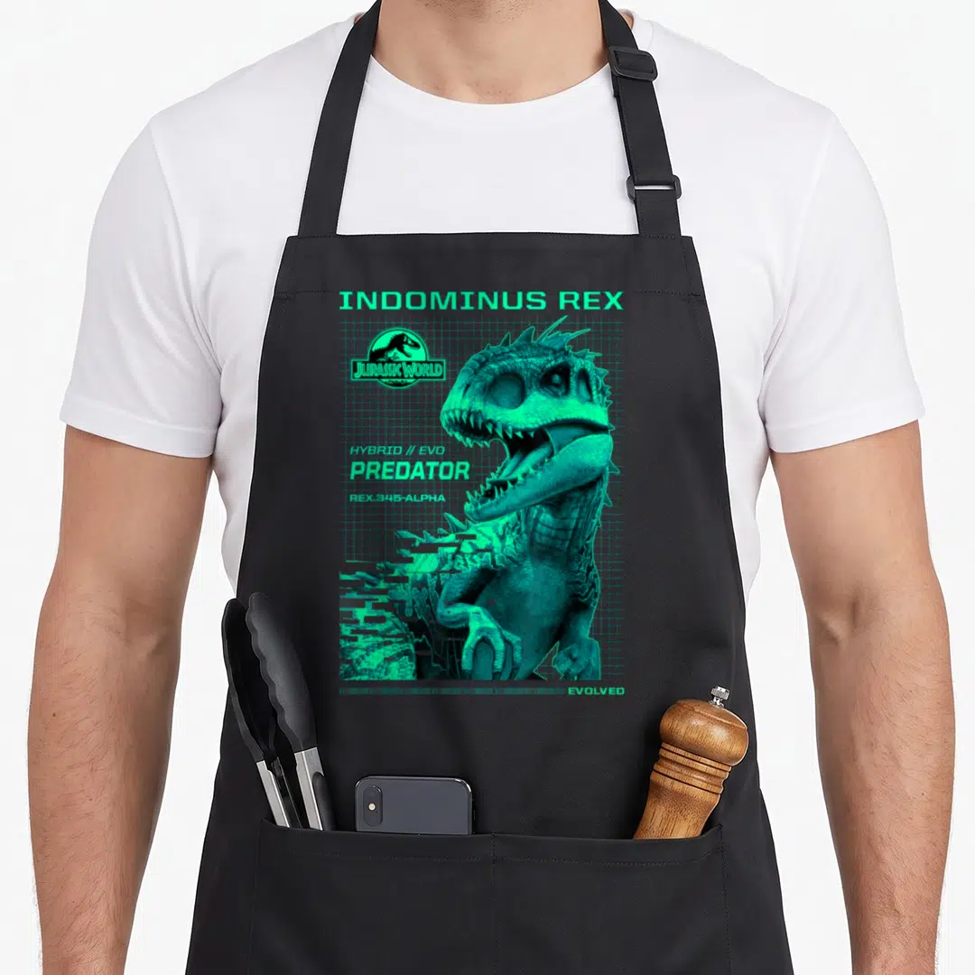 Jurassic predator apron - Cyan Indominus Rex with grid background and text INDOMINUS REX PREDATOR — shown on a black cotton canvas apron against a white background