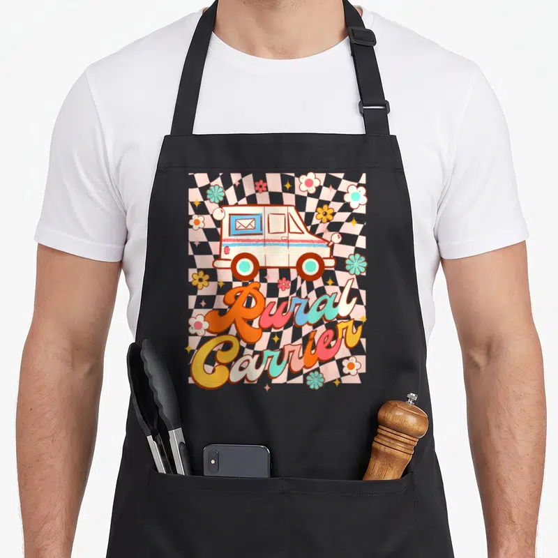 Mailman postman postal aprons - Retro mail truck and Rural Carrier script on wavy pink checkerboard — shown on a black cotton canvas apron against a white background