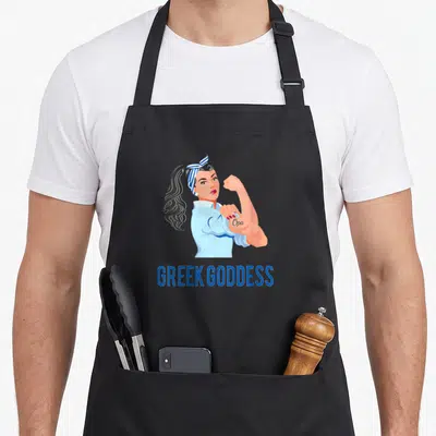 Goddess strong greek aprons - Cartoon woman flexing bicep with Opa tattoo and Greek Goddess text below — shown on a black cotton canvas apron against a white background