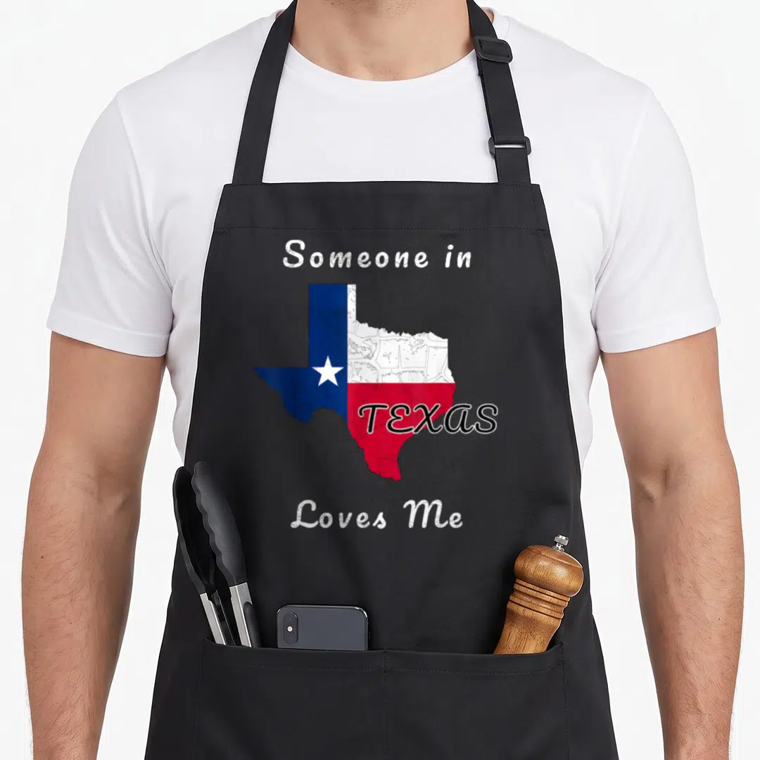 Someone travel aprons - Texas state map outline filled with blue white and red flag colors and surrounding text — shown on a black cotton canvas apron against a white background