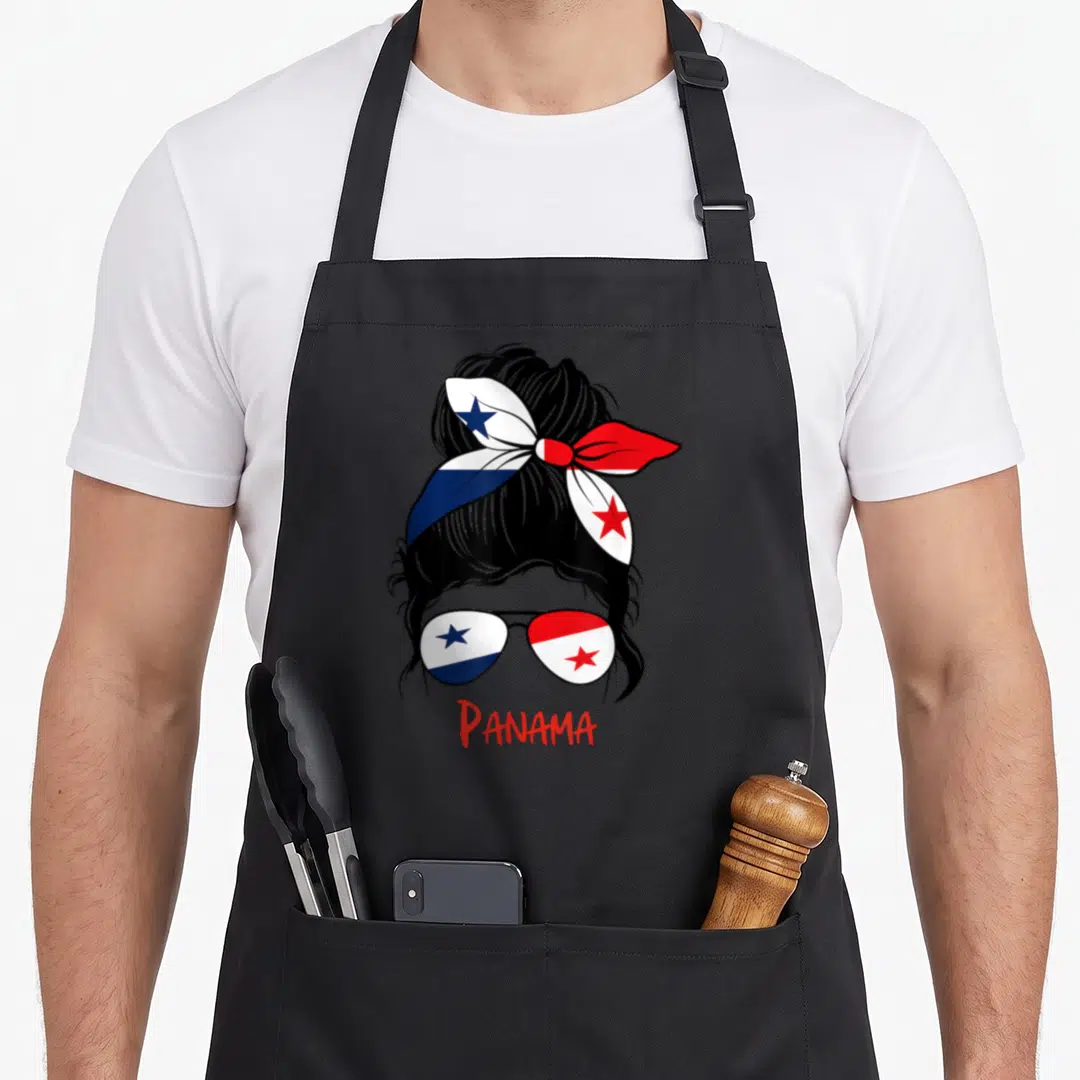 Chica panamanian girl apron - Stylized woman head with bun and sunglasses reflecting Panamanian flag, red PANAMA text — shown on a black cotton canvas apron against a white background