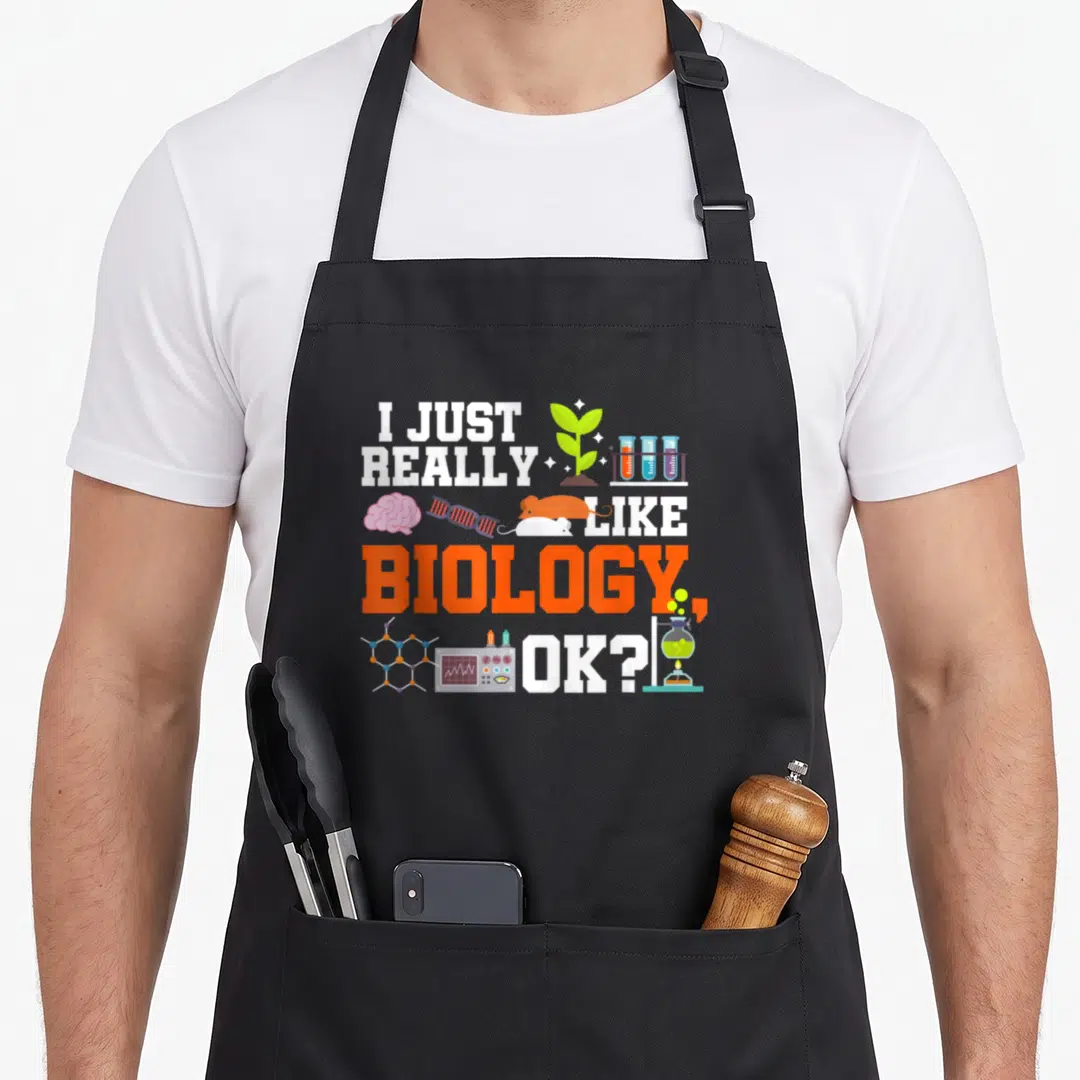 Biology science teacher apron - Stacked text I JUST REALLY LIKE BIOLOGY OK with plant, brain, DNA, mouse, and flask — shown on a black cotton canvas apron against a white background