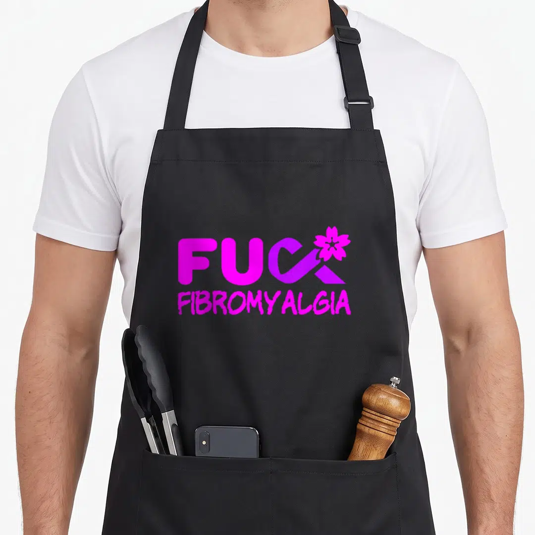 Fibromyalgia chronic fatigue awareness apron - Magenta FUC FIBROMYALGIA text with purple ribbon-K and flower graphic — shown on a black cotton canvas apron against a white background