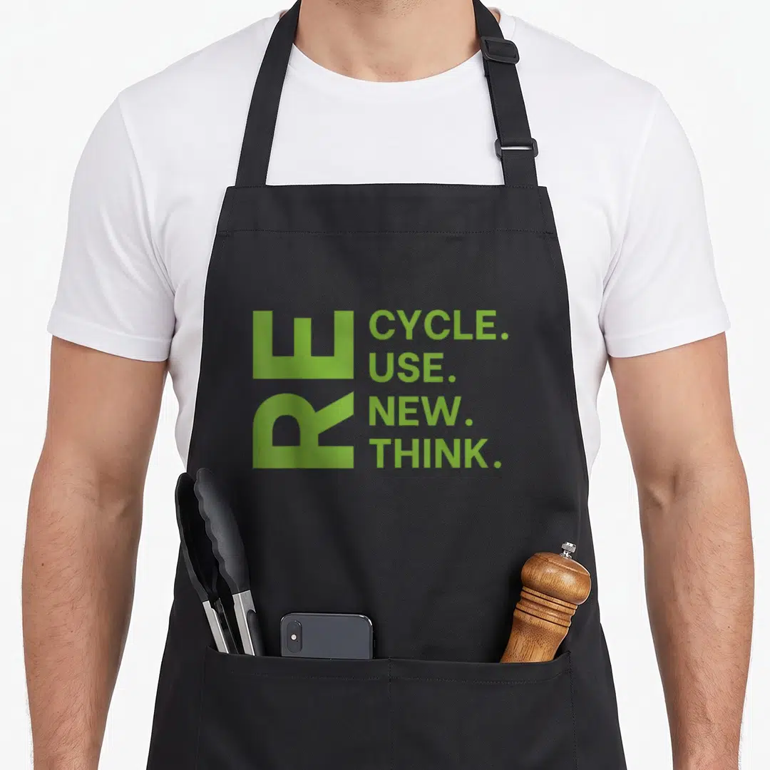 Recycle ecologist apron - Lime green text RECYCLE USE NEW THINK stacked vertically with large RE initials — shown on a black cotton canvas apron against a white background