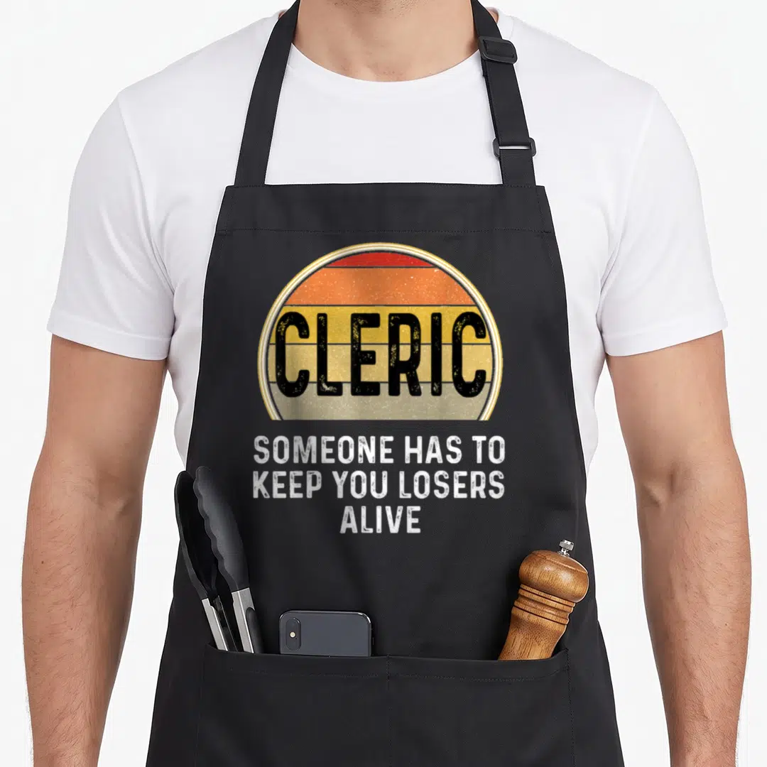 Cleric game aprons - Retro striped circle with CLERIC text and white caption Someone Has To Keep You Losers Alive — shown on a black cotton canvas apron against a white background