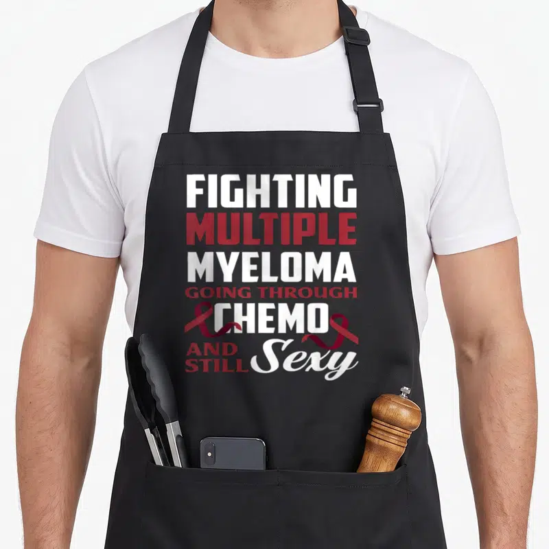 Multiple combat apron - Fighting Multiple Myeloma Going Through Chemo And Still Sexy text with red ribbons — shown on a black cotton canvas apron against a white background