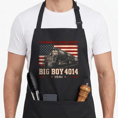 Railroad steam locomotive apron - Big Boy 4014 steam engine graphic with American Iron text over distressed flag — shown on a black cotton canvas apron against a white background