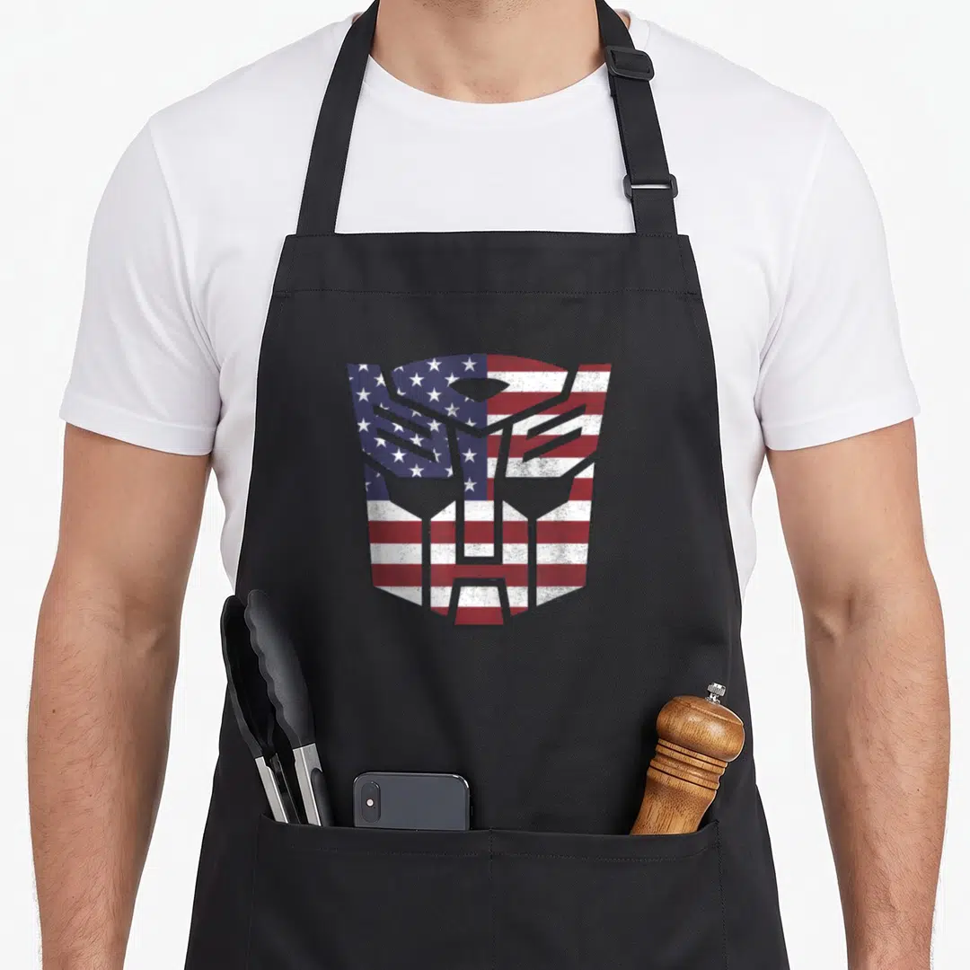 Autobot american flag apron - Distressed Autobot logo filled with red white and blue stars and stripes pattern — shown on a black cotton canvas apron against a white background