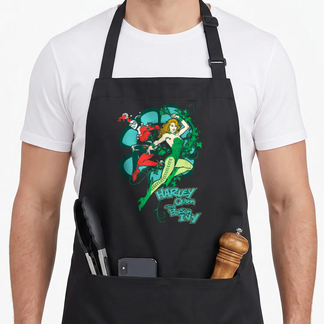 Ivy vehicle apron - Poison Ivy and Harley Quinn illustration with teal flower and stacked text — shown on a black cotton canvas apron against a white background